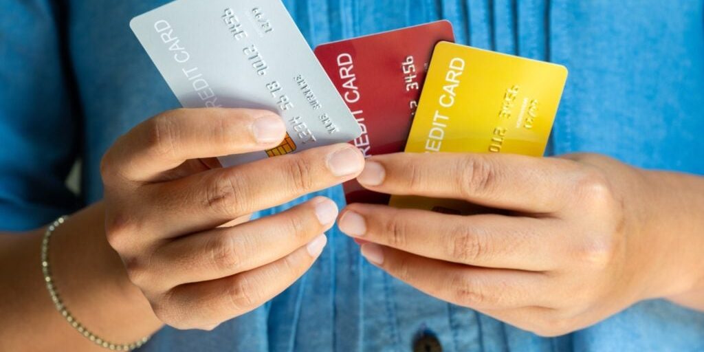 Man-Holding-Several-Credit-Cards-And-He-.jpeg