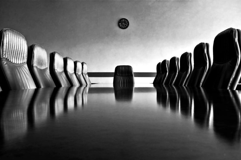 meeting-room-with-a-big-polished-table-and-arm-chairs-gettyimages-172189268.jpg